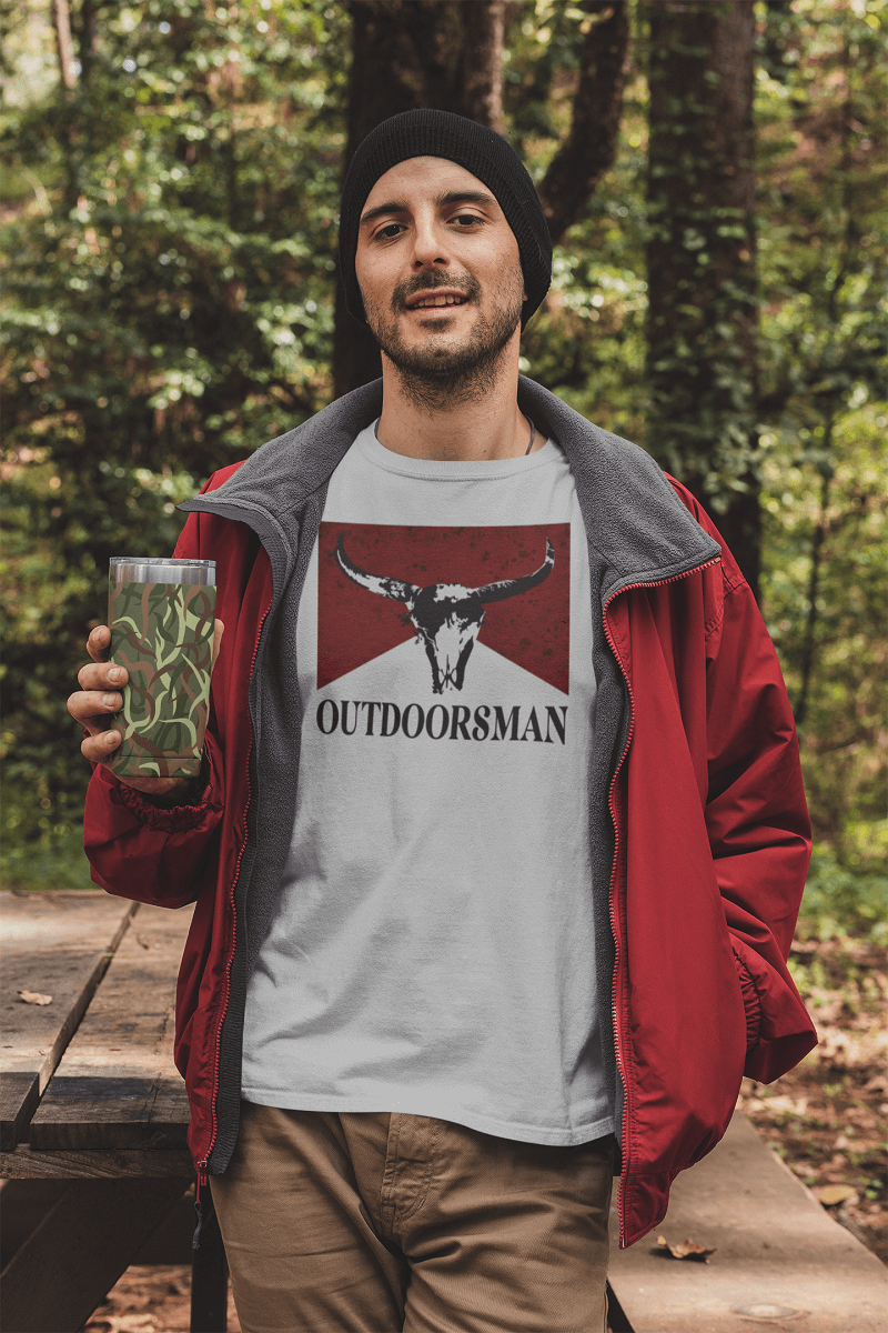 t shirt mockup featuring a man holding a 20 oz travel mug in the woods 30486 1